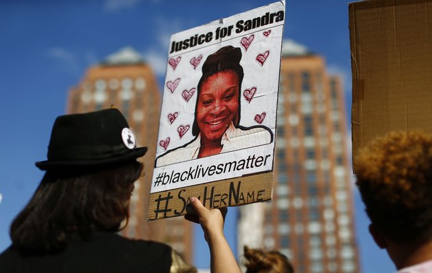 A woman holds a poster bearing the portrait of Sandra Bland, a 28-year-old black woman who killed herself in a Texas jail cell on July 13th, during a Michael Brown memorial rally on Union Square August 9, 2015 in New York. Demonstrators showed support on the one year anniversary on the death of 18-year-old Michael Brown, an unarmed black teen who was shot and killed in Ferguson, Missouri by a white police officer, Darren Wilson, throwing America's troubled race relations into harsh relief. AFP PHOTO / KENA BETANCUR (Photo credit should read KENA BETANCUR/AFP/Getty Images)
